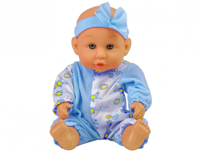 Păpușă bebeluș cu oliță și bandă cu fundiță 24 cm