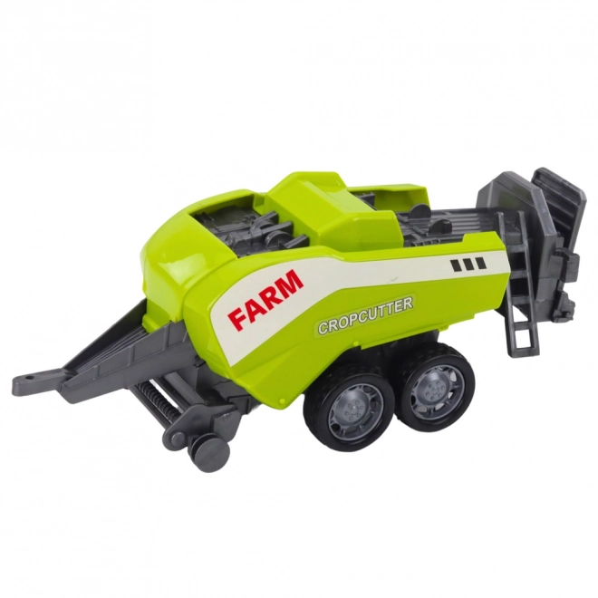 Tractor roșu cu încărcător și presă de balotat