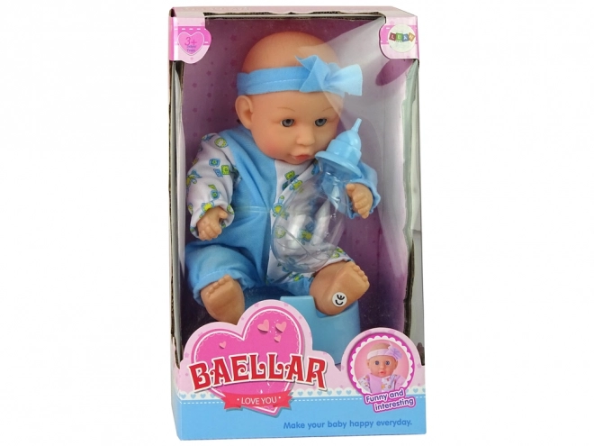 Păpușă bebeluș cu oliță și bandă cu fundiță 24 cm