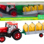 Tractor mare cu remorcă și baloți de fân